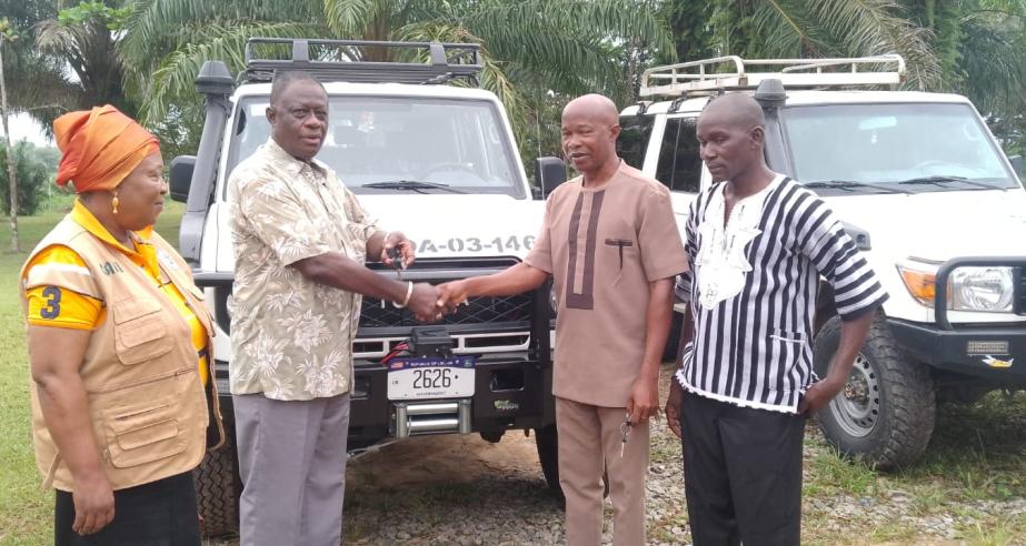 Dr. Arthur Bob. Karnuah, receives keys of Toyota Land Cruiser SUV from, Mr. Jobson A. Momo, SDCA.