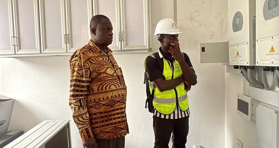 Dr. Karnuah inspects electrical system at one of the solarized laboratories.