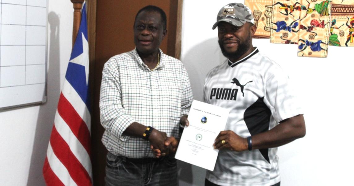 After the engagement meeting, Dr. Karnuah hands over the CARI Strategic Initiatives Document to Dr. Joekai