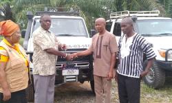 Dr. Arthur Bob. Karnuah, receives keys of Toyota Land Cruiser SUV from, Mr. Jobson A. Momo, SDCA.