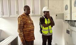 Dr. Karnuah inspects electrical system at one of the solarized laboratories.