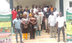 Dr. Arthur Bob Karnuah, CARI Director General, Jobson Momo, SDCA Director General, flanked by participants, including Research Assistants, smallholder farmers, women, and youth groups.