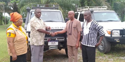 Dr. Arthur Bob. Karnuah, receives keys of Toyota Land Cruiser SUV from, Mr. Jobson A. Momo, SDCA.