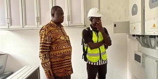 Dr. Karnuah inspects electrical system at one of the solarized laboratories.