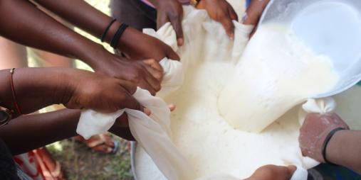Farmers and students, working closely with the CARI nutritionist, carefully sieve freshly prepared soybean milk.